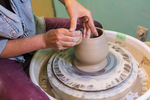 1 Throw a water-droplet shaped pot with a small base that inflates to a rounded fullness and tapers up to a narrow rim.