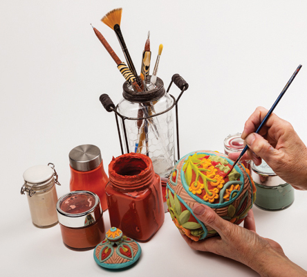12 Choose your underglaze color palette. Use a fan brush on the inside and small detail brushes everywhere else.