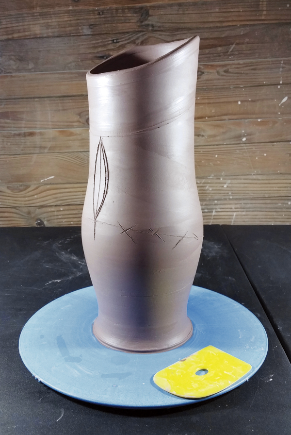 2 Cut the rim at an angle and begin dart drawings (back view).