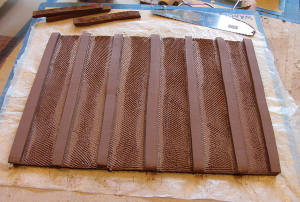 4 Add feet to the bottoms of trays larger than 10 inches square. Place the feet about 1 inch apart.