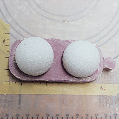 1 The cutout should measure 7½ in. across and 3½ in. wide. Place the 2½ in. Styrofoam balls on top to give reference.