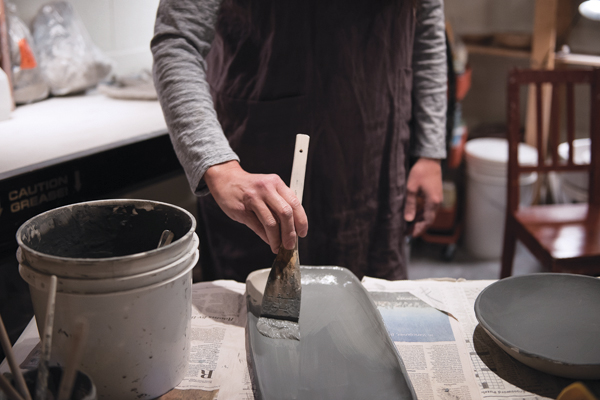 1 Apply two even coats of slip to the leather-hard clay form. Allow the slip to dry between coats.