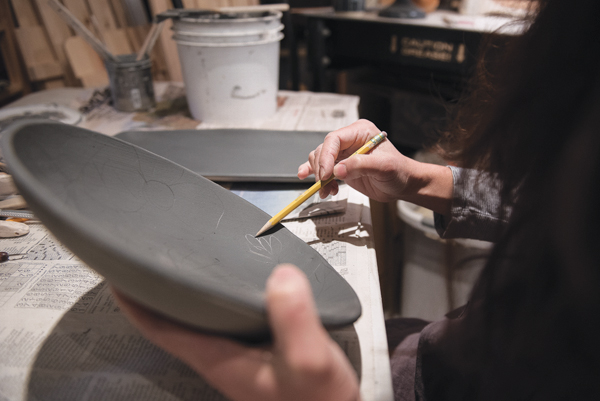 2 Using a dull pencil, sketch your design or pattern onto the chalky slip surface.