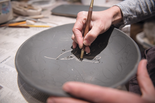 3 With a small loop tool, outline the negative spaces of the drawn design or pattern.