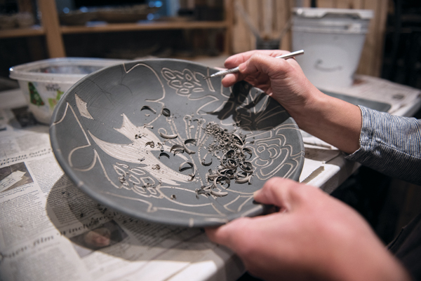 7 With the design now outlined, begin to lightly remove the slip from the negative spaces.