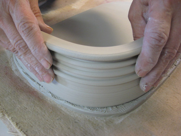 4 Score and apply slip to the bottom slab and wall pieces before attaching. Place walls ¼ inch in from the edge of the slab.