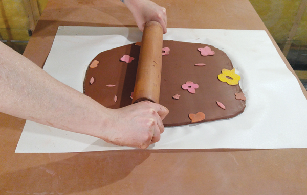 1 Rolling craft-foam cutouts into a 3⁄8 -inch thick slab.
