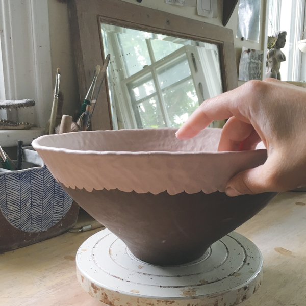 8 Pinch and smooth the added coil for height and shape using both hands (one shown for clarity).