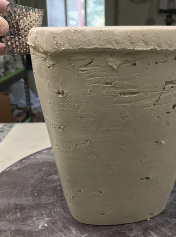 11 Score the attachment area, add slip, then compress and taper the bottom slab.