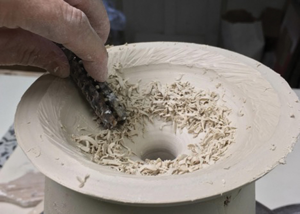 12 Using a round Surform, remove clay from the inside of the top.
