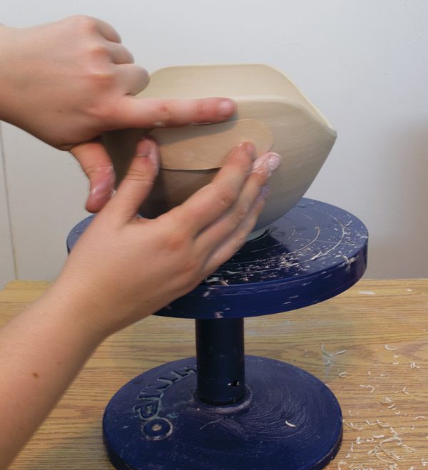 4 Trace and cut the handle holds using a template. Repeat on the opposite end.