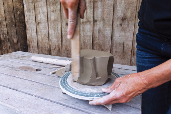 2 Having completed the faceting, create indents and shape the bowl by hitting it with a piece of wood.