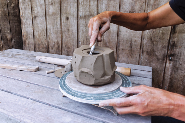 4 With the opening created, carve some clay out, leaving about ½ in. (1.5 cm) thick walls.
