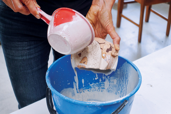 11 Glaze the outside of the bowl by pouring a shino glaze over sections of the surface.