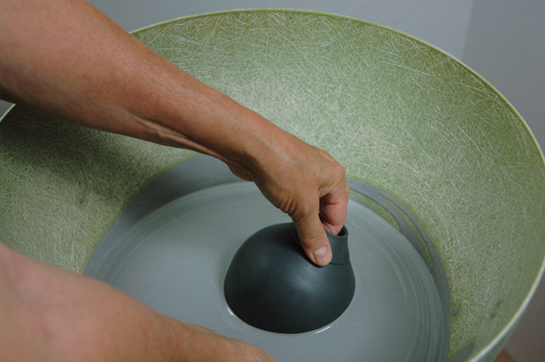 12 Hold the bottle’s top, steady the base with the other hand, and push down into slip.