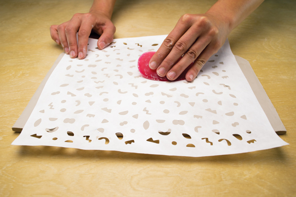 1 Affix the die-cut Tyvek stencil on a ¼-inch-thick slab.