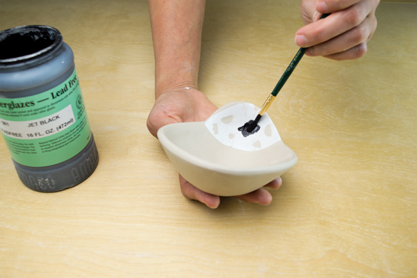 8 Paint underglaze over a stencil resist on both sides of the handle.