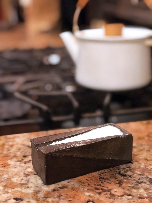 Spice server with kosher salt on kitchen counter.
