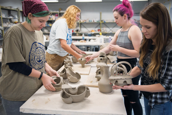 1 Students with their finished provotype assignments. From left to right: Gabzy Rinker, Becca Low, Spencer Dewey, and Julie Schmitt. Photo: Steven Casanova.