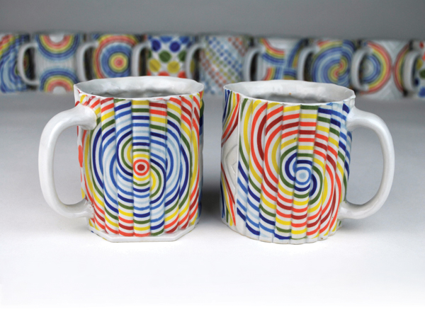Mugs, press-molded porcelain, slip-cast inclusions, fired to cone 6 in reduction, 2018. 