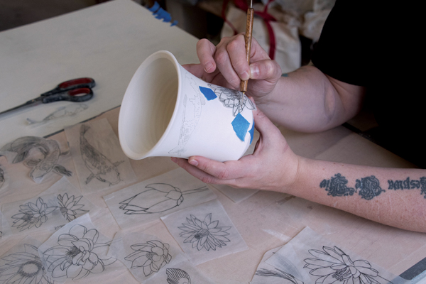 2 Transfer pencil drawings to the bone-dry clay surface by tracing with a stylus tool.