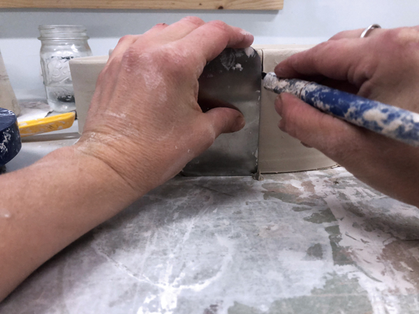 2 Cut the oval in half using a rib tool to make sure it’s straight.