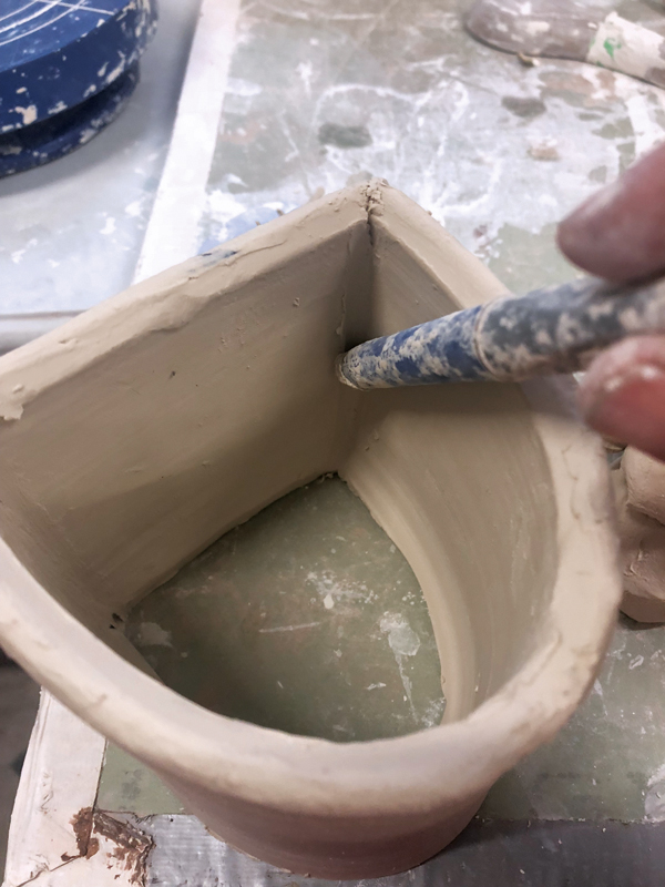 3 Score, then attach the slab. Smooth the inside of the seam.