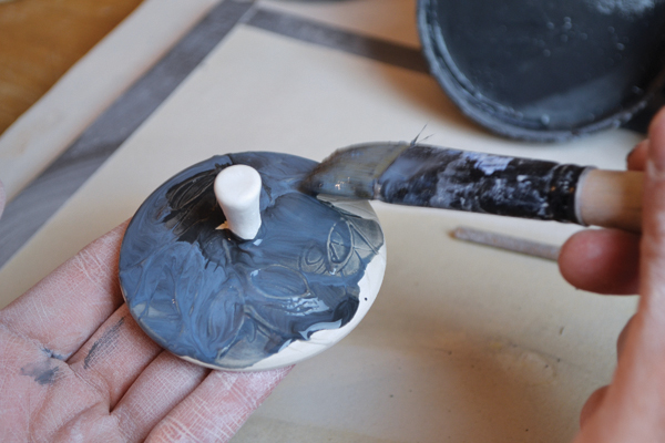 10 Once the pots are dry, brush underglaze washes over the imagery.