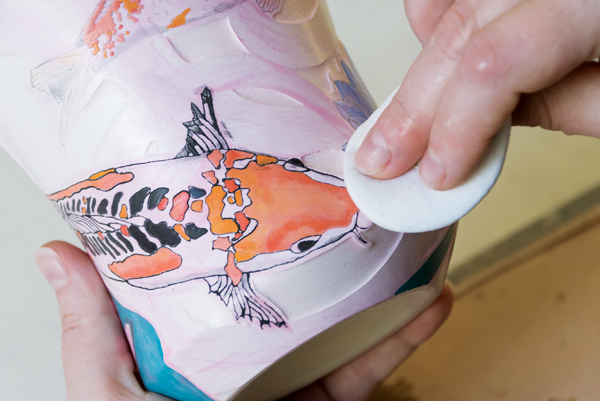 11 Once applied, wipe off the excess black underglaze wash leaving behind the inlaid drawing.