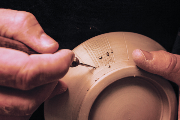 6 Scribe decorative lines into the bottom section for later underglaze application. 