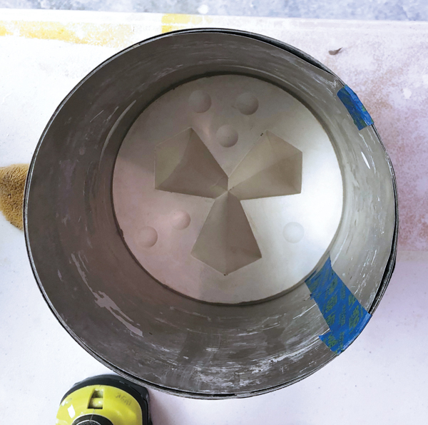 10 Pour plaster onto the first mold part to create a mother mold.