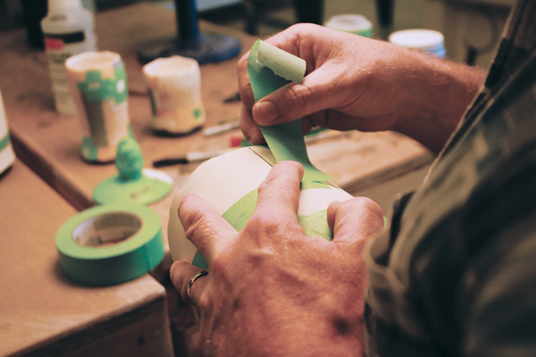 11 Apply underglaze to the incised lines, then choose sections to be glazed. Apply masking tape to protect adjacent sections from overspray.