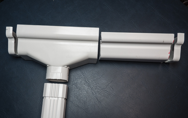 1 Parts from left to right: endcap, downspout fitting with a downspout, section of gutter, endcap.