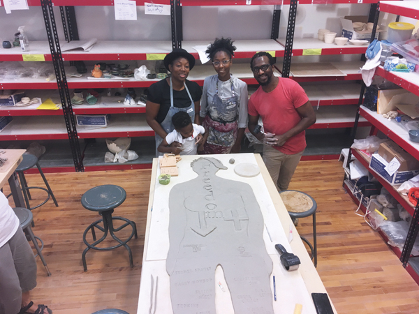 1 Participants from Black Lives Matter and The Fugitive Slave Chapel Preservation Society making tile figures for Canada 150 Mosaic at London Clay Art Centre. 