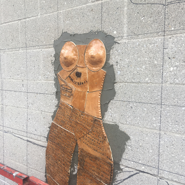 8 Installing Indigenous woman figure on the mosaic. 