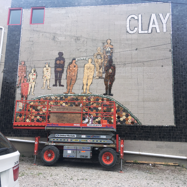 9 Image taken 1/3 of the way through installation of the mosaic, showing the completed border, several figures, the turtle shell, and marks on the wall indicating the placement of additional compositional elements.