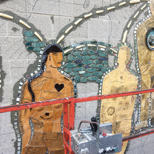 10 Close-up of Indigenous woman figure surrounded by cut mirror pieces and water tiles. 