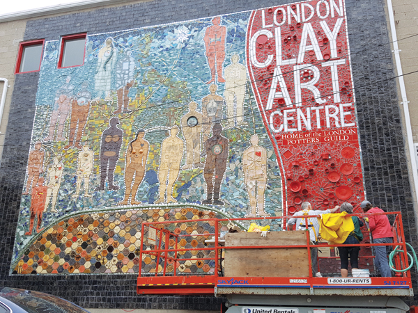 12 Rob Hodson, Susan Day, and Beth Turnbull Morrish wiping away excess grout and polishing tiles on the Canada 150 Mosaic at London Clay Art Centre, 2017. Photo: Preston Gervais. 