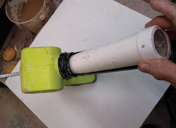6 Insert assembled extruder tube with die and end cap at an angle to fit into the gun and in line with the plunger.