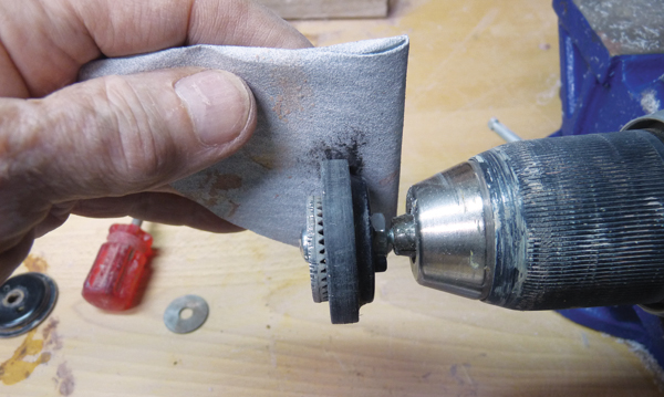 3 After trimming the plunger and backing plate, smooth uniformly with sandpaper while a drill keeps the parts spinning. 