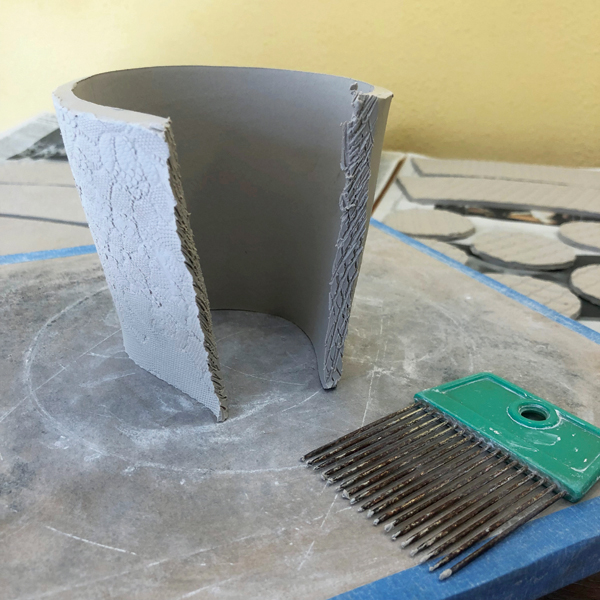 3 Score the attachment areas, apply slip, and seal the seam of your cup form.