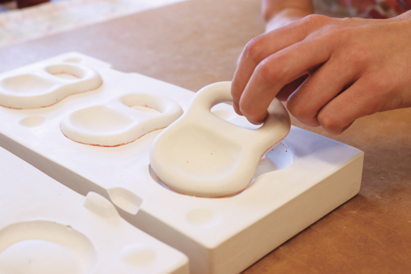 3 Pulling plaster test-tile models from the newly made two-part mold. 