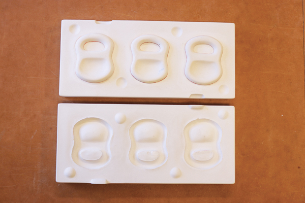 4 Solid cast mold for slip casting test tiles. The holes for pouring the slip are located in the half of the mold under the test tiles. 