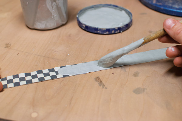 4 Apply slip to both the transfer pattern on newsprint and the pot.