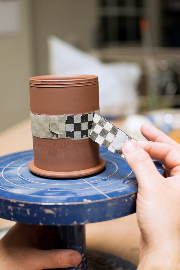 5 Apply the transfer to the pot, allow it to dry, and carefully peel off the newsprint.