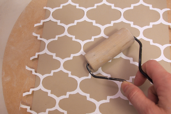 5 Lightly press the stencil into the slab using a pony roller.