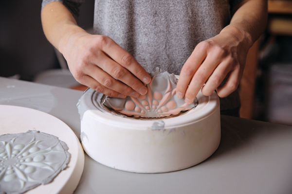 7 Peel clay out of the mold. Release the edges first and work toward the center.