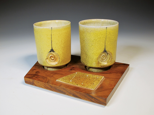 5 Pair of tumblers, 9 in. (23 cm) in width, wheel-thrown white stoneware, off-white terra sigillata, black slip trailing, glaze, fired to cone 11–12 in moderate reduction, recycled African pallet wood with inlaid tile, 2018.