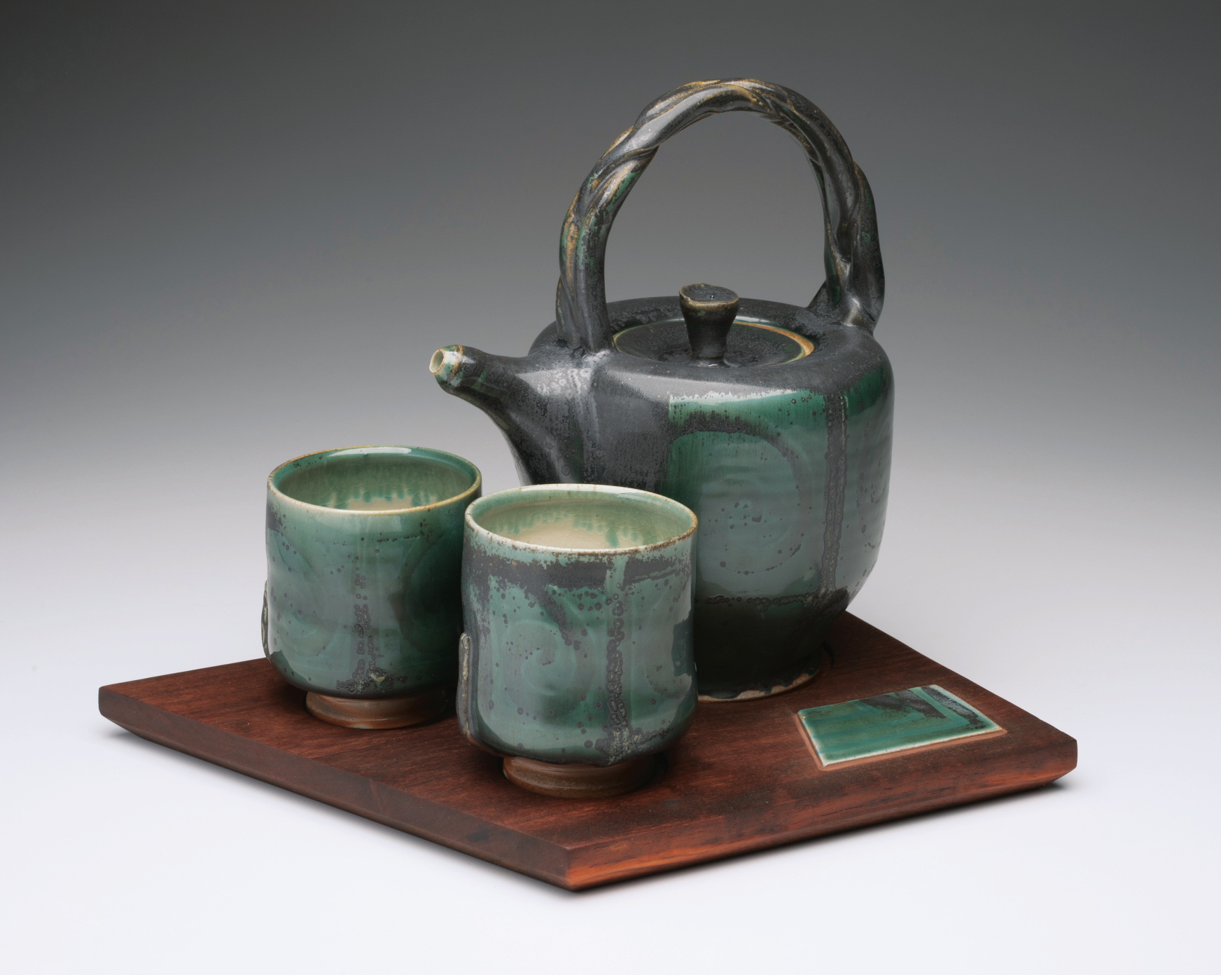 1 Tea for Two, 12 in. (30 cm) in height, wheel-thrown white stoneware, Bermuda Green terra sigillata beneath Rob’s Green glaze, fired to cone 11–12 in heavy reduction, recycled African pallet wood with inlaid tile, 2017.