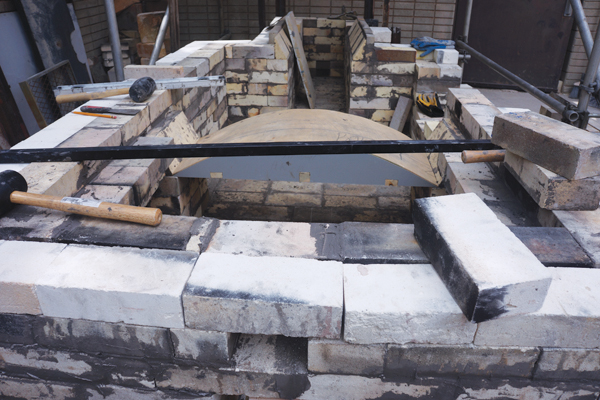 4 By the end of day 2, the locations of the firebox, ware chamber, and opening to the chimney were clearly visible and the form for casting the flue was placed.